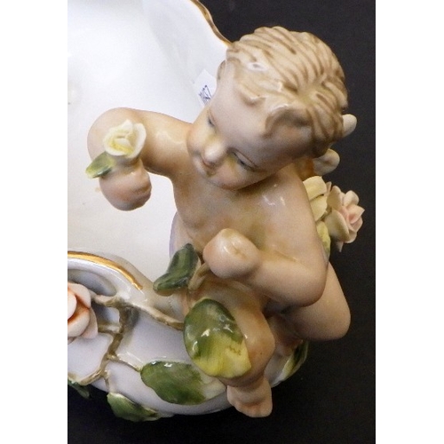 5 - A Meissen bowl decorated with Cherubs, 15cm tall 23cm wide