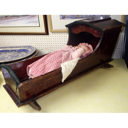 54 - An Armand Marseille doll in a pine crib together with a 20thC bisque doll in a wicker crib (2)