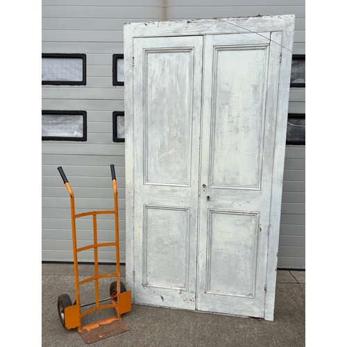 726 - A large Victorian painted pine two door cupboard, 234cm tall, 127cm wide (wheels not included)