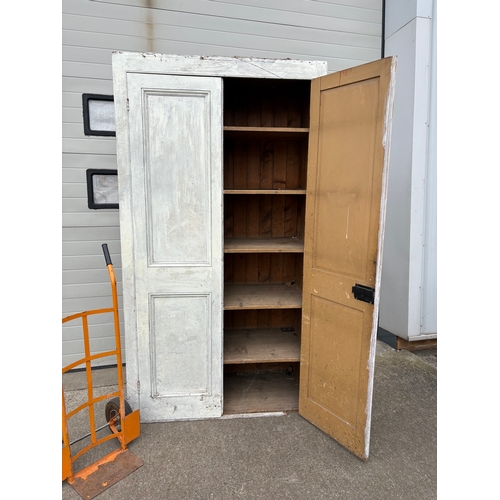 726 - A large Victorian painted pine two door cupboard, 234cm tall, 127cm wide (wheels not included)