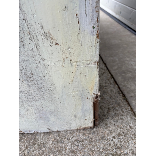 726 - A large Victorian painted pine two door cupboard, 234cm tall, 127cm wide (wheels not included)