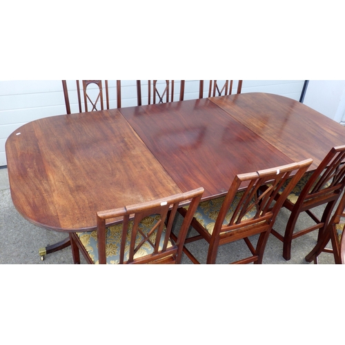 642 - A mahogany twin pillar dining table with one leaf, 226cm long x 107cm, together with a set of seven ... 