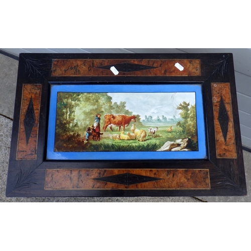 689 - A 19th cen ebonised side table with ceramic panel depicting a rural scene, missing lower finial, 57c... 