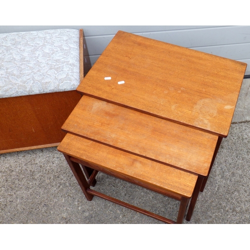 707 - A teak nest of three occasional tables, with drawer,  together with an ottoman (2)