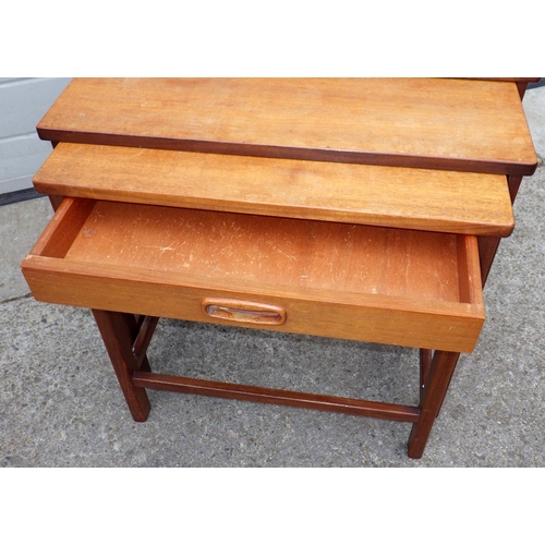 707 - A teak nest of three occasional tables, with drawer,  together with an ottoman (2)