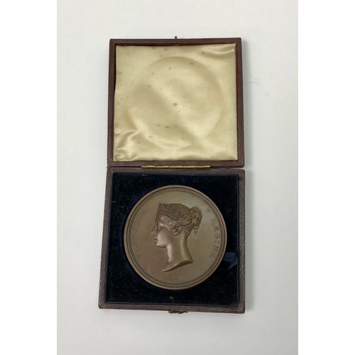An early Victorian bronze medallion, by W Wyon R.A. "In Honour of Her Majesty's Visit to The Corporation of London 9th Nov: 1837"  the obverse depicting an uncrowned bust, the reverse depicting the Guildhall with the Royal Standard flying, the hard leather case bearing gilt tootling "Art-Union of London".  55mm diameter.