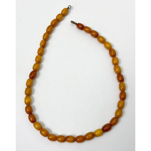 A string of dark butterscotch amber beads, approx 460mm long / largest bead approx 10 x 8mm.  A/F chips to ends etc.