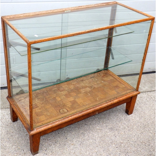 An oak framed shop flat cabinet, frame loose, with parquet floor, 107cm wide