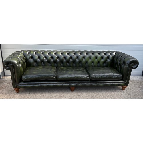 A large, oversized green leather Chesterfield sofa 270cm long. Distinctive Chesterfields handmade in England