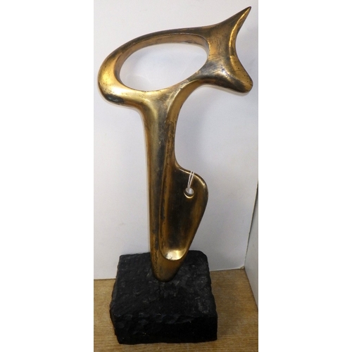 An abstract bronze sculpture on a marble base