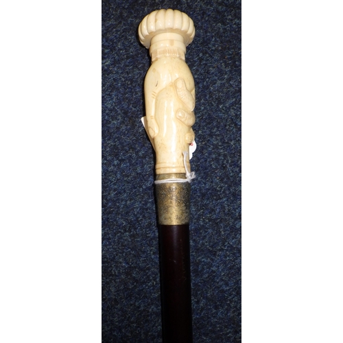 A bone handled walking stick with handle in the form of a hand