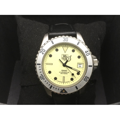 A gents Tag Heuer 1000 quartz watch with yellow face and date