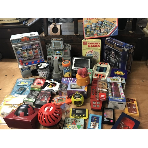 2334 - A box containing a collection of handheld games and boxed puzzles