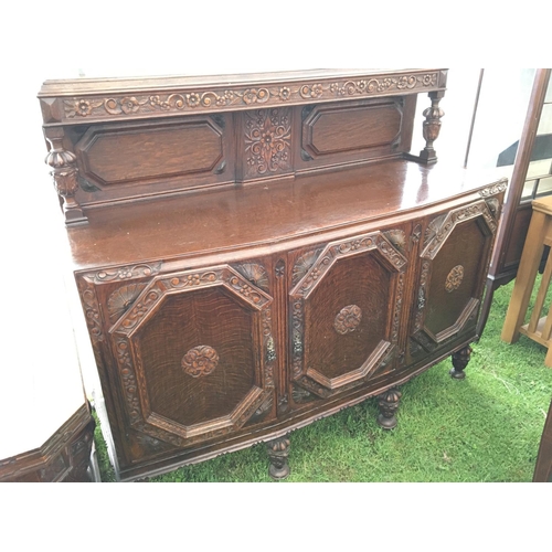 198 - A Quality oak extending dining table with carved bulbous supports and a matching sideboard (2)