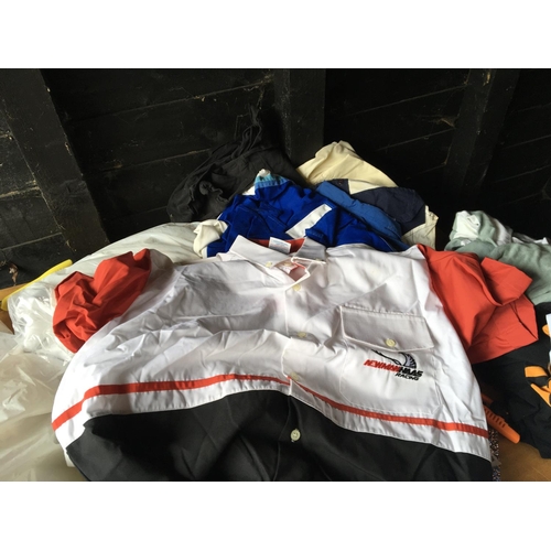 58 - A box containing vintage sports shirts including Formula 1 shirts.