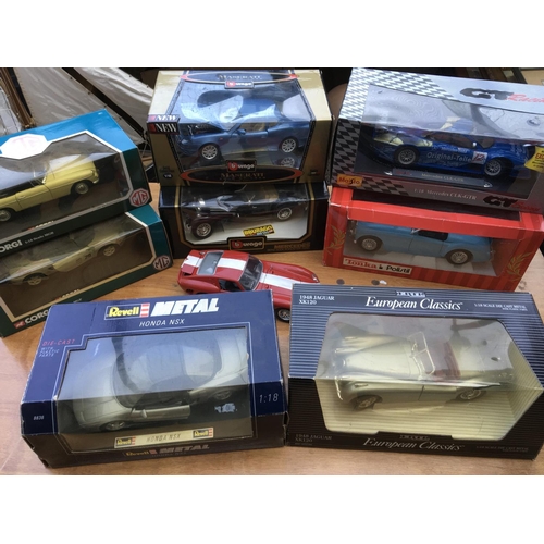 259 - A collection of boxed diecast vehicles including 1:18 scale models by Corgi, Revell, ERTL, Maisto, B... 