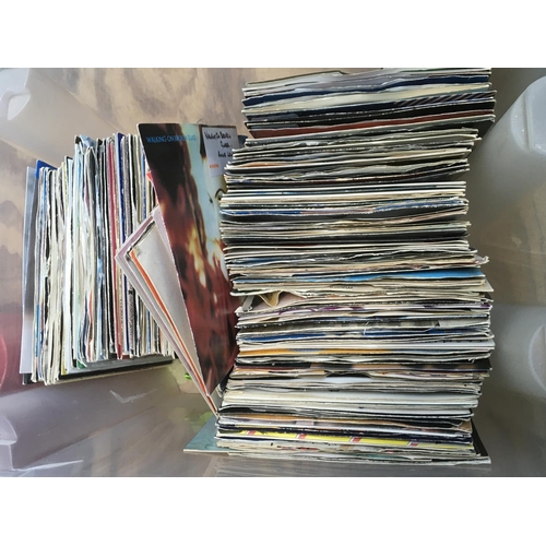 140 - Two boxes of 7 inch singles mainly from the 1980s and 90s plus a small collection of Beatles books.