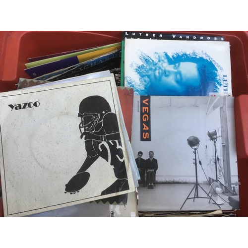 140 - Two boxes of 7 inch singles mainly from the 1980s and 90s plus a small collection of Beatles books.