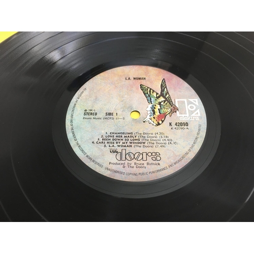 169 - Two LPs by The Doors comprising a first UK pressing of 'LA Woman' K42090 and 'Absolutely Live'. VG+/... 