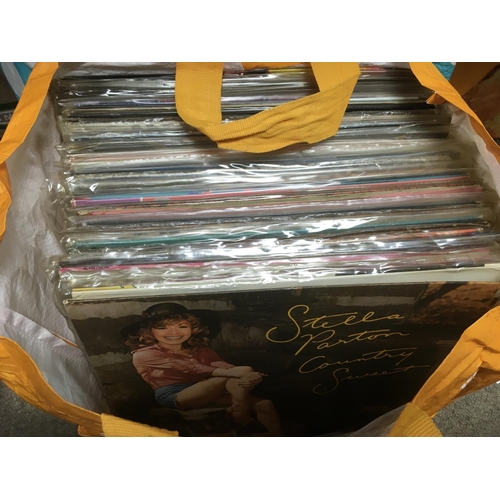 243 - Three bags containing a large collection of country music LPs.