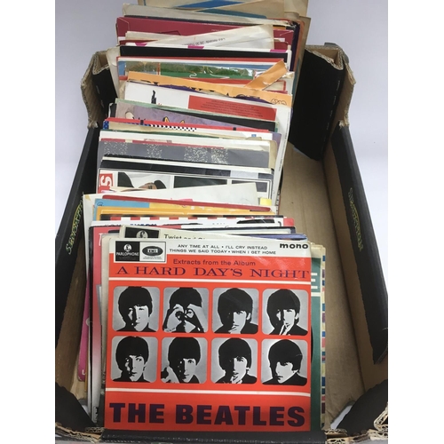 261 - A collection of 7 inch singles and EPs by various artists including The Beatles,