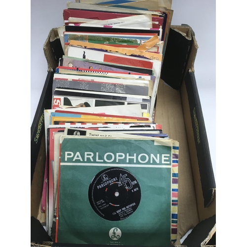 261 - A collection of 7 inch singles and EPs by various artists including The Beatles,