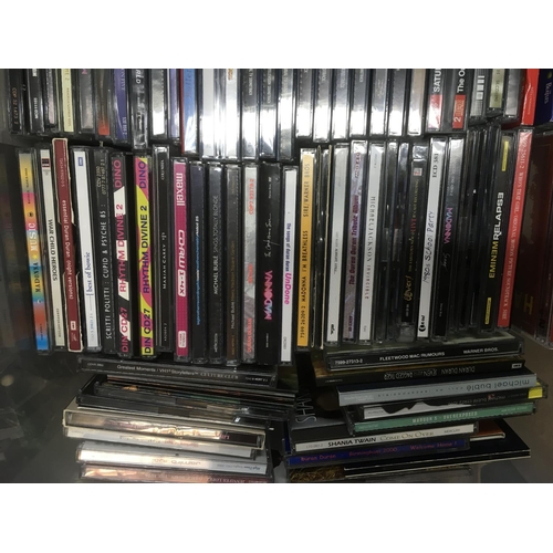 313 - Four boxes of CDs by various artists including Bon Jovi, Madonna, The Beatles and many more.