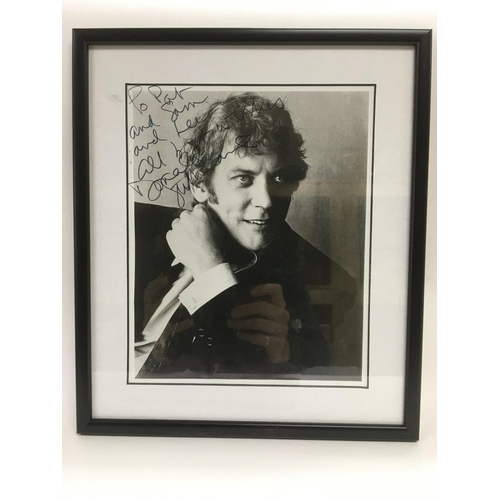 540 - A framed and glazed signed and dedicated photo of Donald Sutherland, approx 29cm x 33.5cm.