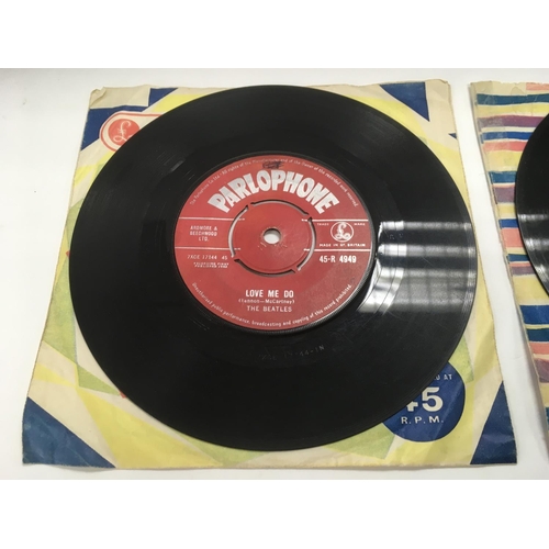 7 - Two early UK issues of The Beatles single 'Love Me Do' b/w 'P.S. I Love You' with red labels and rig... 