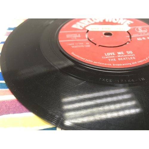 7 - Two early UK issues of The Beatles single 'Love Me Do' b/w 'P.S. I Love You' with red labels and rig... 