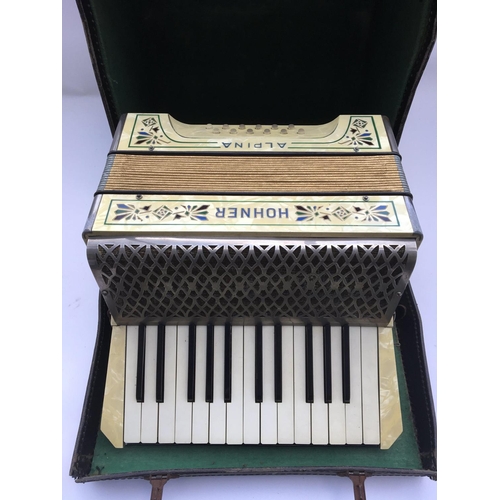 823 - A cased Hohner Alpine accordion.