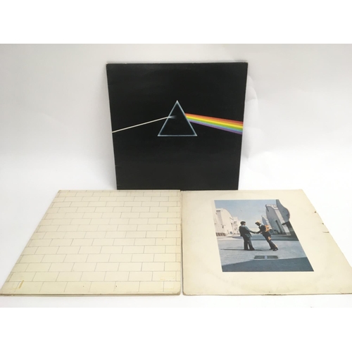 88 - Three Pink Floyd LPs comprising 'Wish You Were Here', 'Dark Side Of The Moon' and 'The Wall'.
