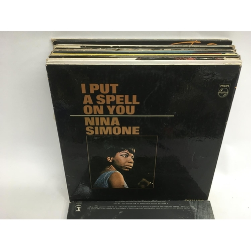 89 - A bag containing LPs by various artists including Neil Young, Lou Reed, Nina Simone and others.