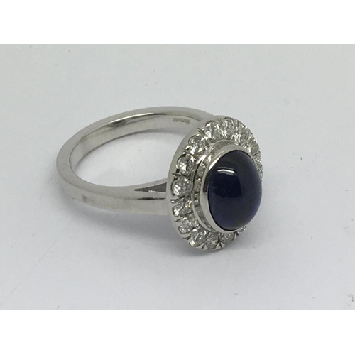 83 - An 18ct white gold diamond and cabuchon sapphire cluster ring, approx 8.9g and approx size O