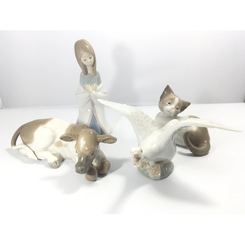 1106 - A collection of Lladro figures a calf a cat a goose and a figure of a kneeling girl. No damage (4)