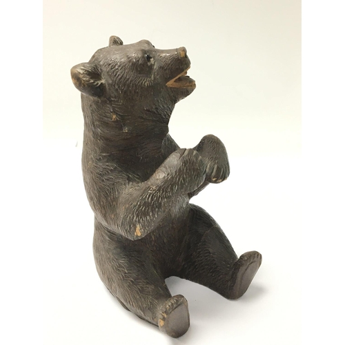 1036 - A 19th century carved wood Black Forest bear with glass eyes height 15cm