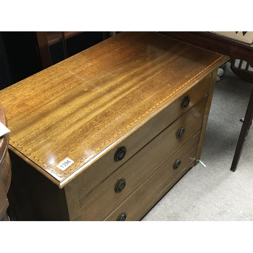 1396 - A small Edwardian inlaid mahogany chest of drawers the rectangular top above three drawers.