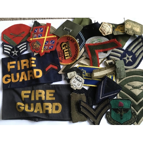 1816 - A collection of military patches together with a statuette of a WW1 British soldier.