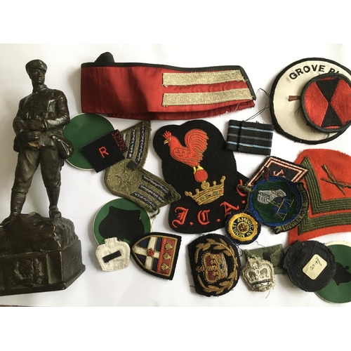 1816 - A collection of military patches together with a statuette of a WW1 British soldier.