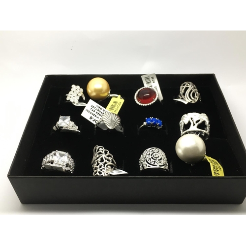 711 - A collection of 12 silver rings, as new.