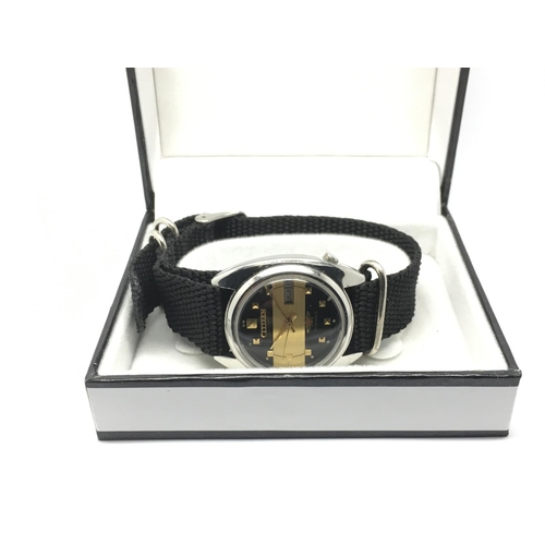 720 - A Citizen automatic watch with black and gold tone dial.