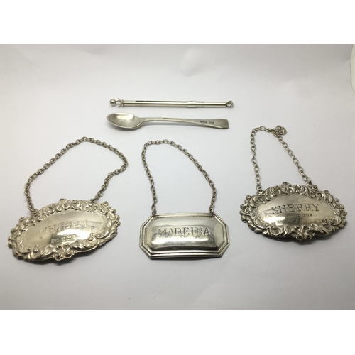 723 - Three silver spirit labels, a silver cocktail stirrer and a silver spoon.