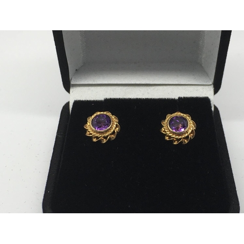 743 - A pair of 9ct gold earrings set with amethyst