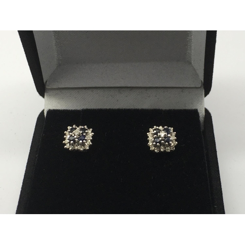 744 - A pair of 9ct white gold earrings set with diamonds and sapphires