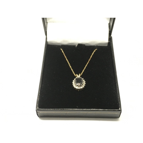 750 - A 9ct gold sapphire and diamond pendant on a 9ct gold chain