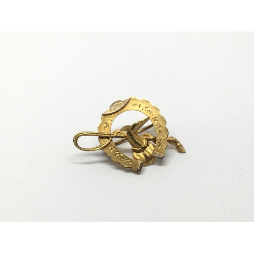 752 - A 9ct gold horseshoe brooch, approx 2g.