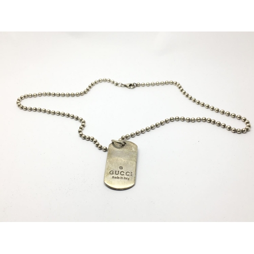 759 - A sterling silver dog tag on chain marked 'Gucci made in Italy'.