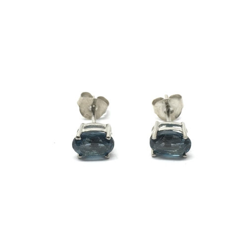 769 - A pair of silver studs set with London blue topaz.