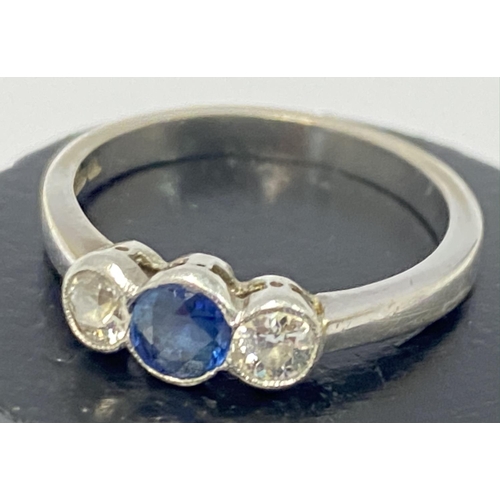 779 - An 18ct white gold sapphire and diamond 3 stone ring, 3.4g, M.