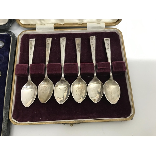 794 - Cased cutlery comprising six silver coffee spoons two cased set of butter knifes with silver handles... 